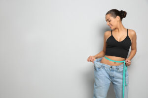 Slim woman in oversized jeans