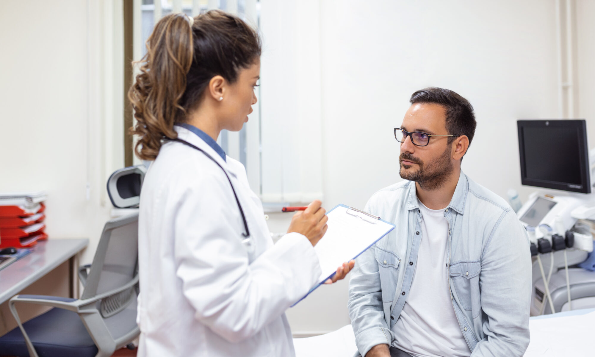 Doctor consulting with male patient — complete guide to HGH therapy for men