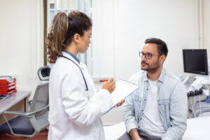 Doctor consulting with male patient — complete guide to HGH therapy for men